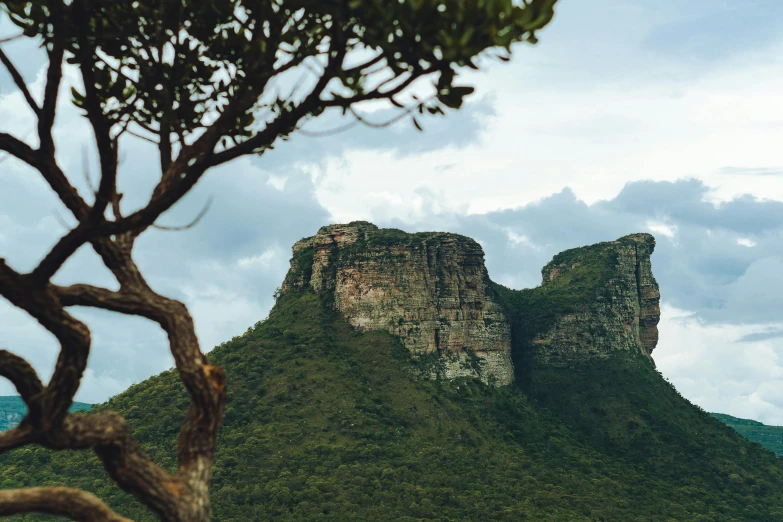 an ancient mountain seen from across the forest