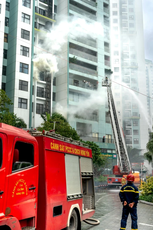 a fireman standing next to a fire truck in the middle of town