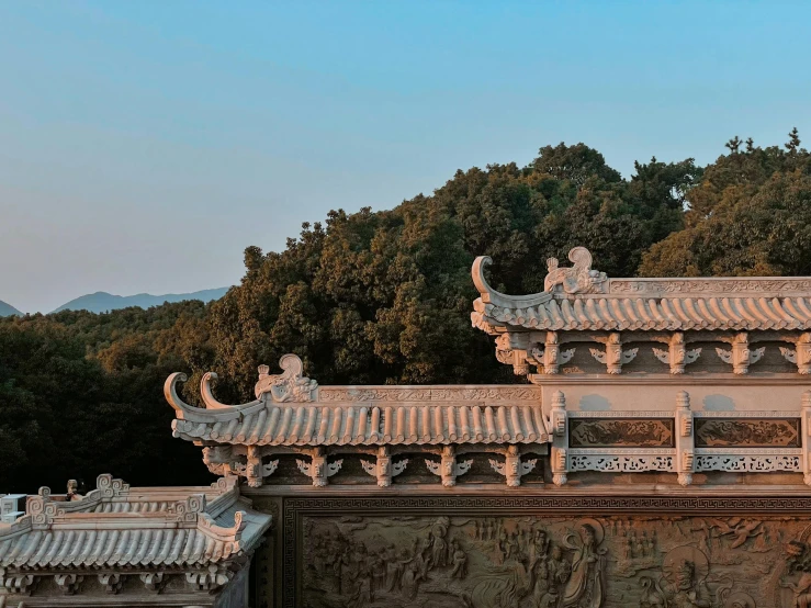 a chinese building with mountains in the background