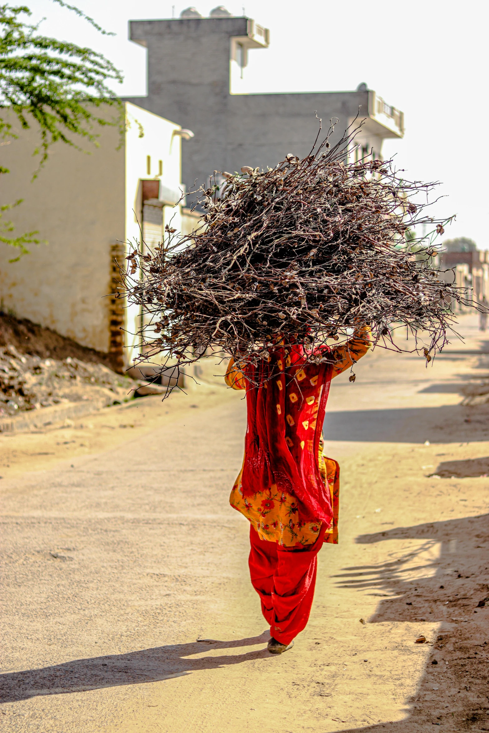 a woman carrying soing in a large amount of place