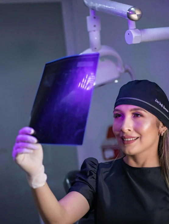 a woman is smiling and showing her dental equipment