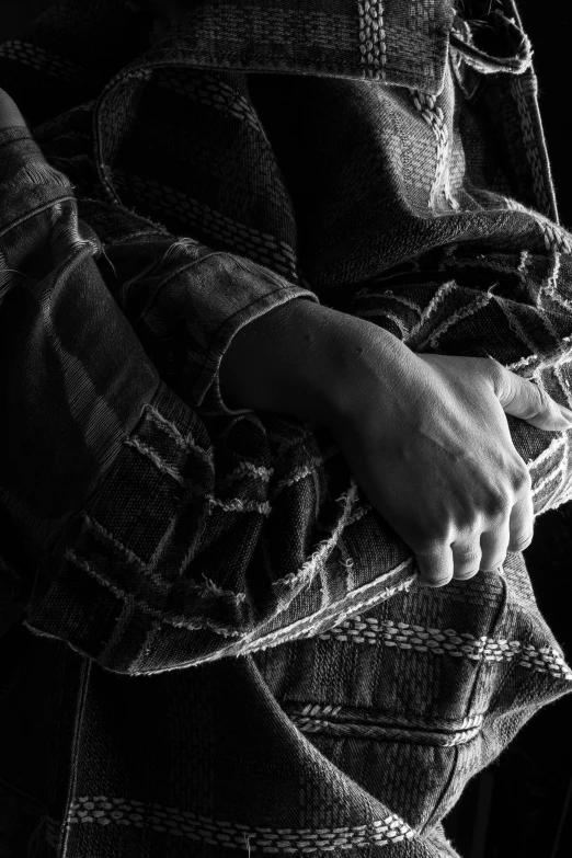 a close up of a person's hand and a dark background