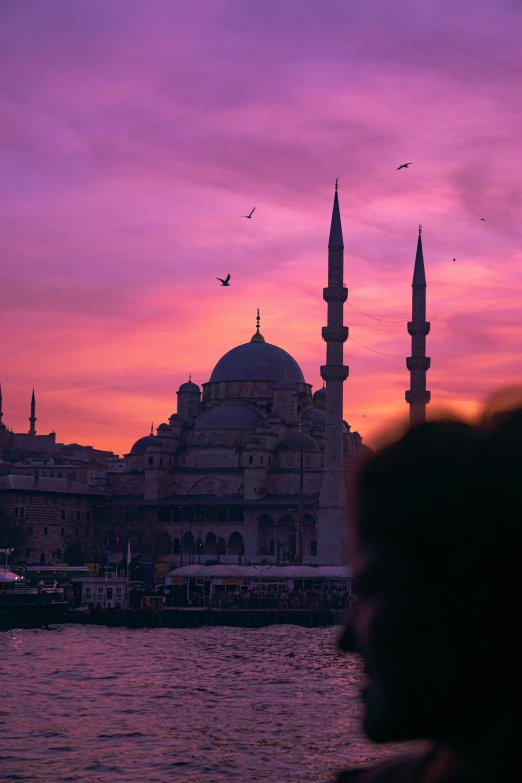 a city with a sunset view behind the building