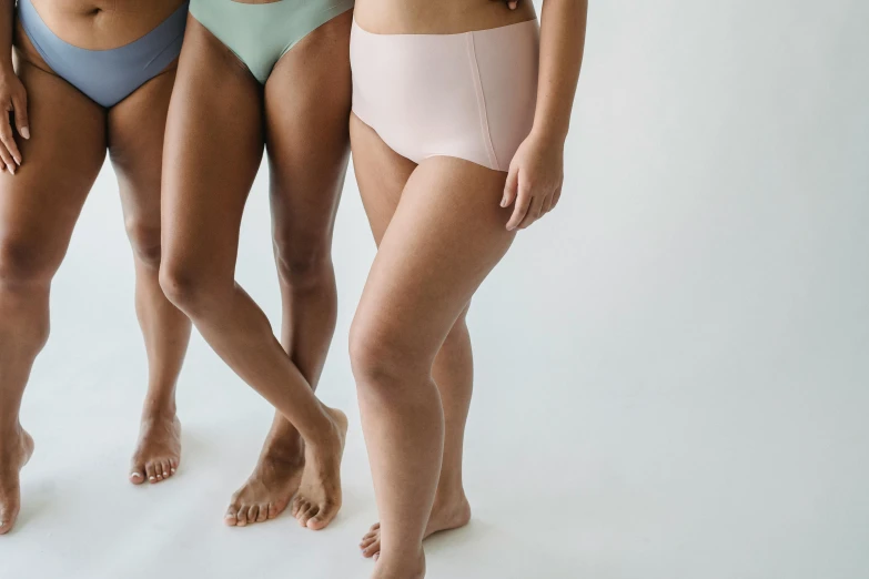 three female models with no clothing posing together