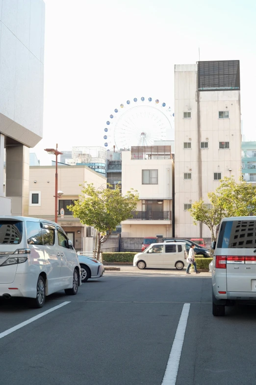 cars wait on the corner of a city street