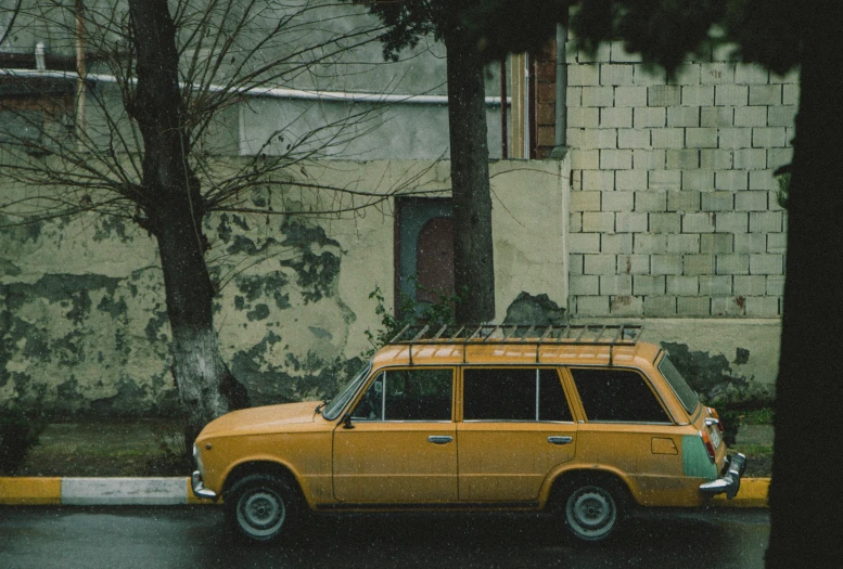 an orange car parked in front of a building