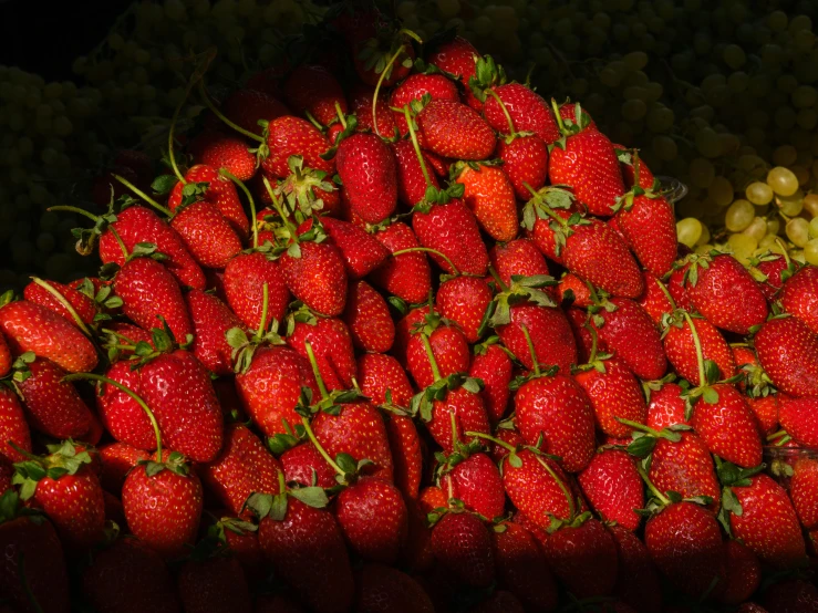 the strawberries are arranged on top of each other