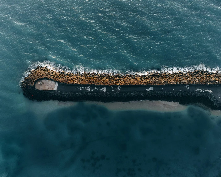 a barge floating on top of water next to shore