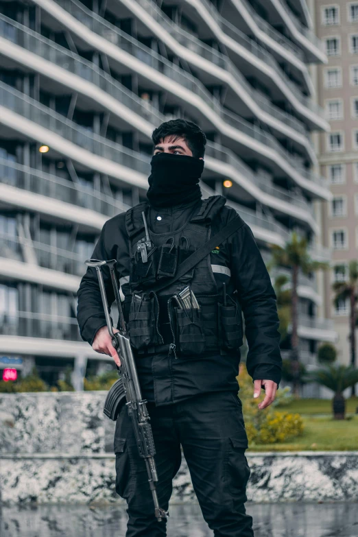 a man with a gun and mask on a street