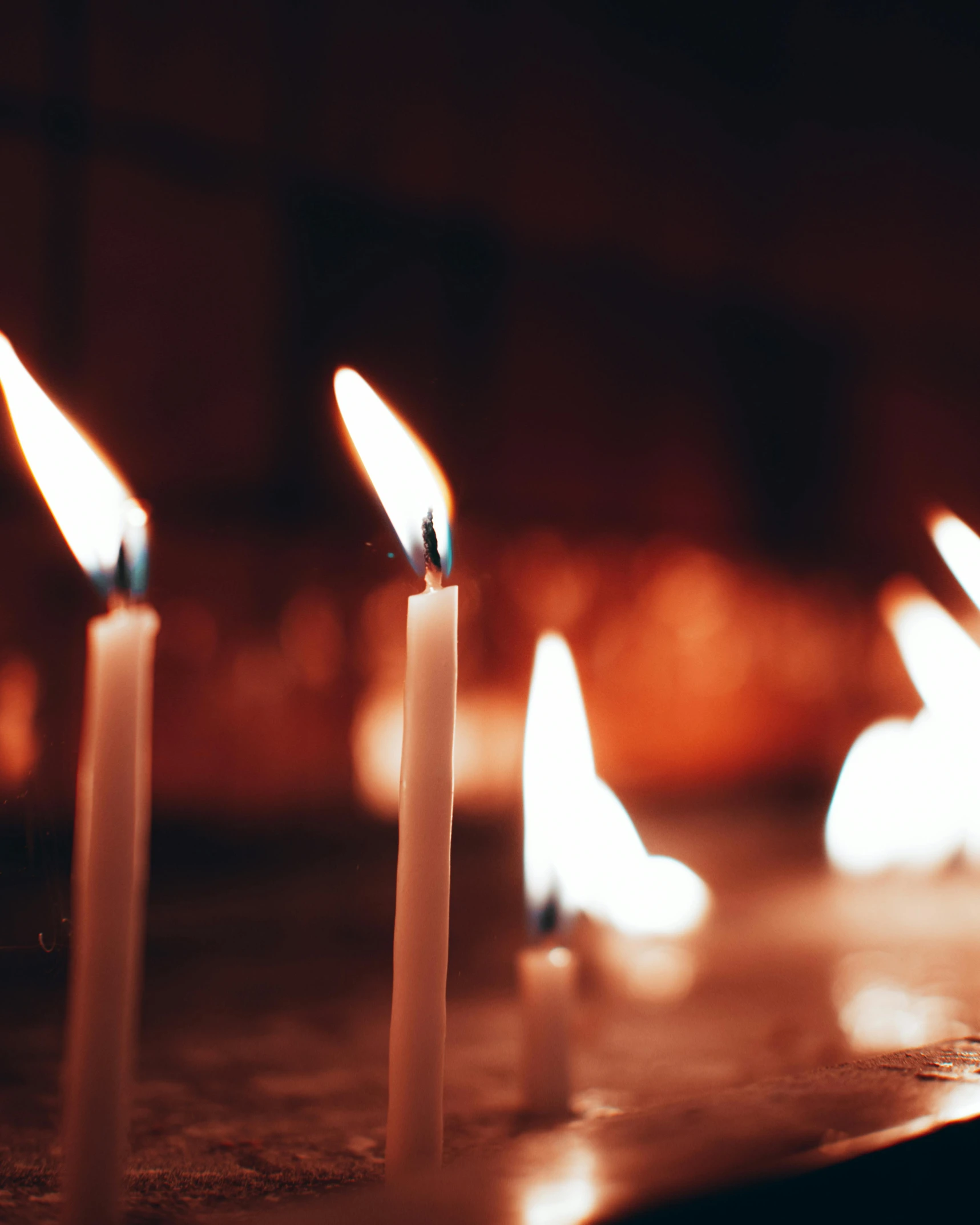 several lit candles sitting on top of a table