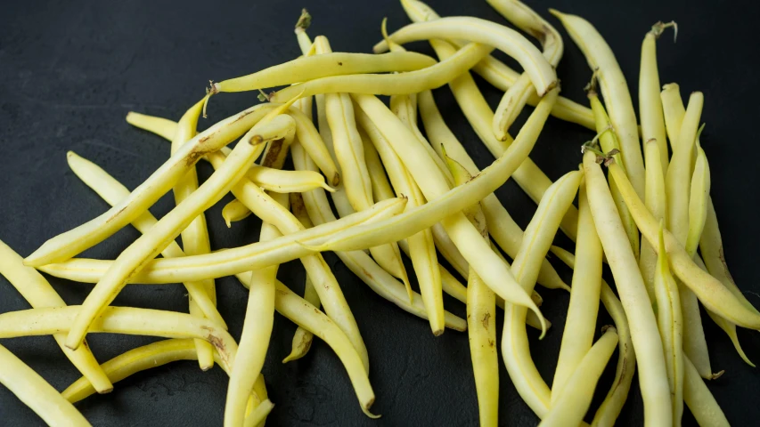 a pile of beans on a black table