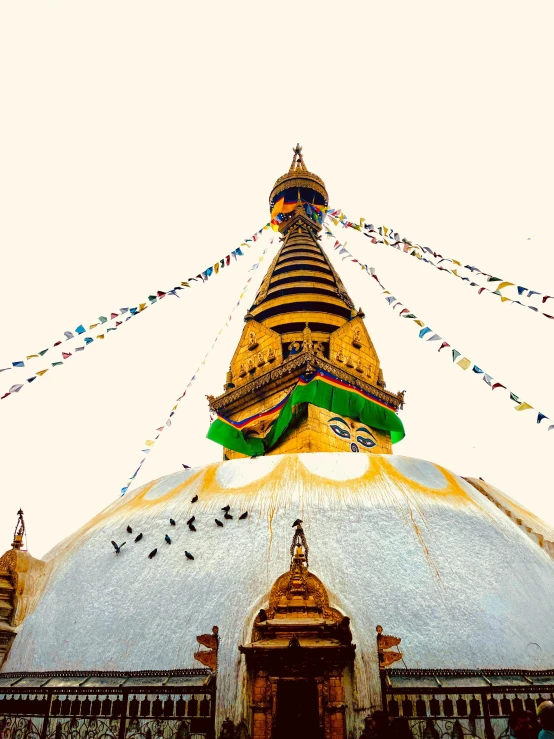 colorful banners hang from the tower of a building