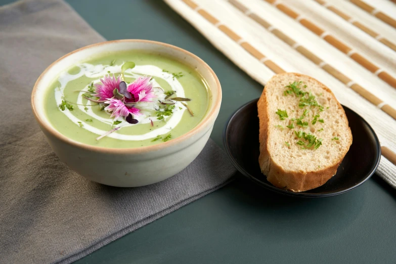 a sandwich and soup in bowls sit next to each other