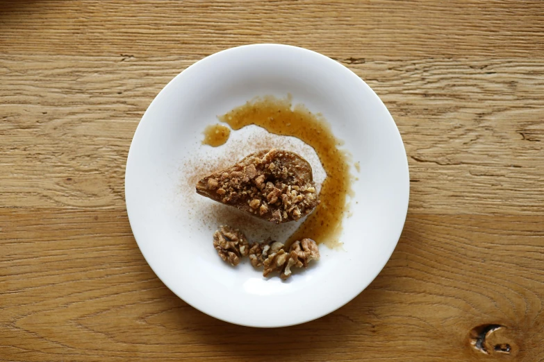 a half eaten dessert is in a white bowl on a table