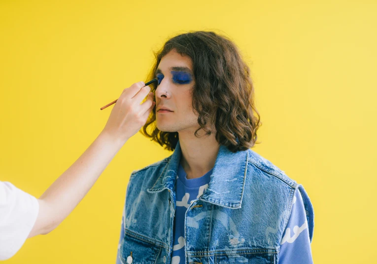 a woman is getting her make up applied to the girl's face