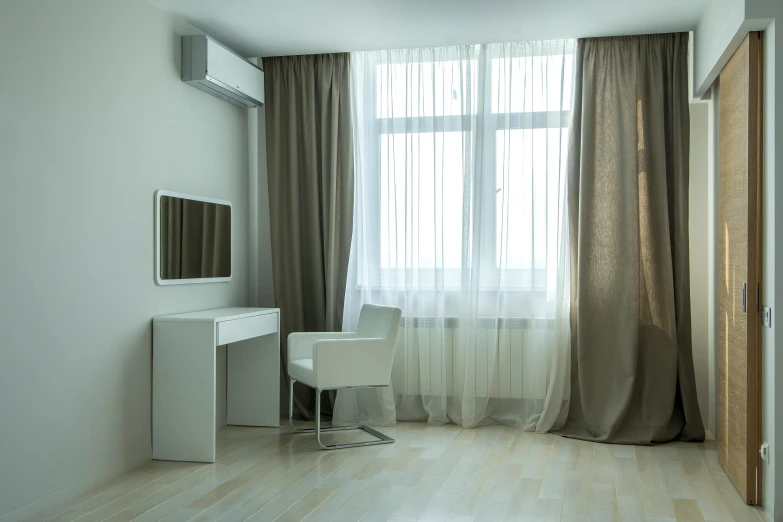 a room with a desk and two white chairs