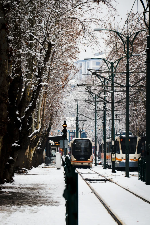 the train is coming down the snowy tracks