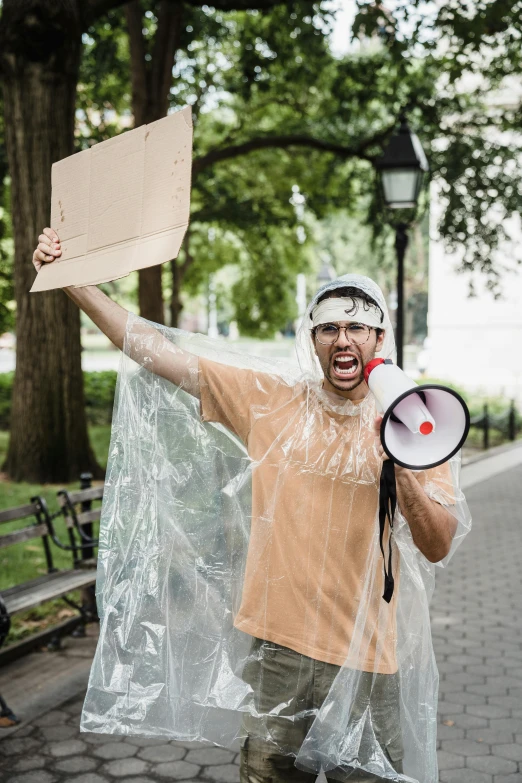 man holding up a sign wearing a protective coat