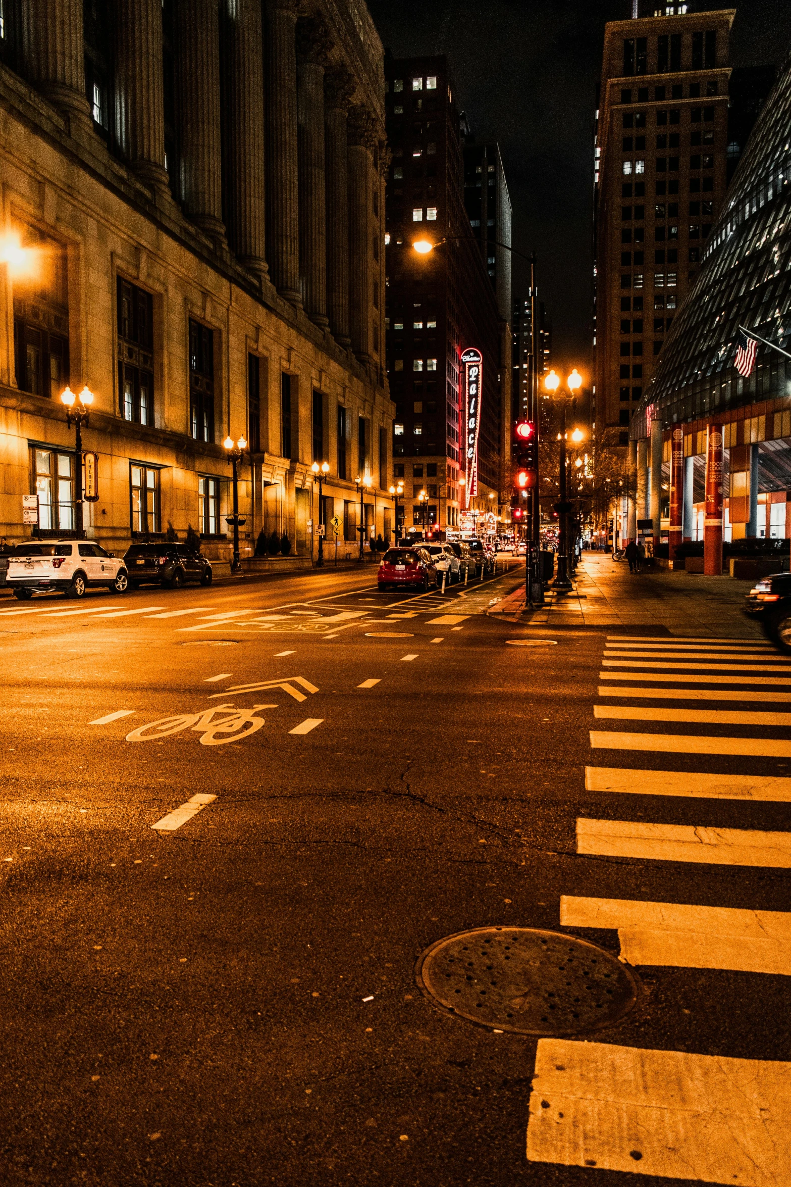 a city street at night with lit up buildings