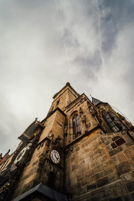 looking up at the side of a tall building with clocks on each end