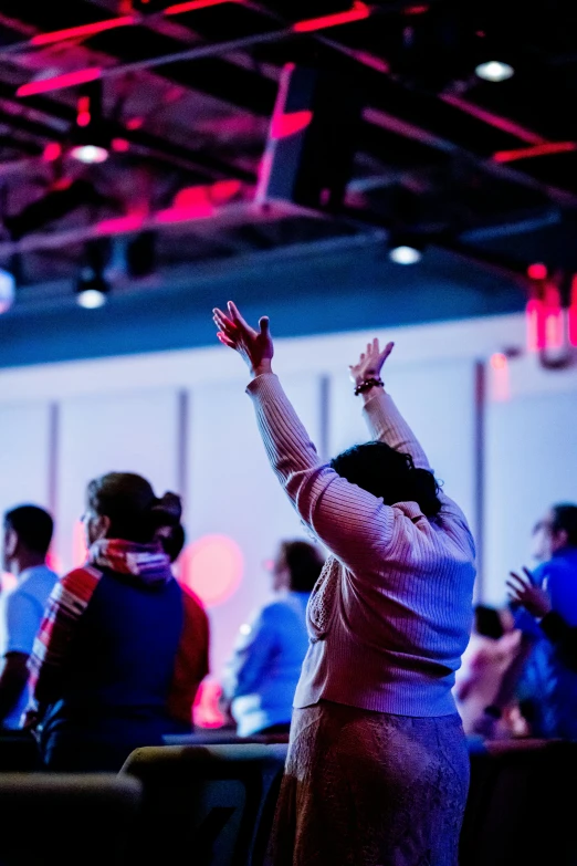 a woman wearing a white dress is throwing her hands