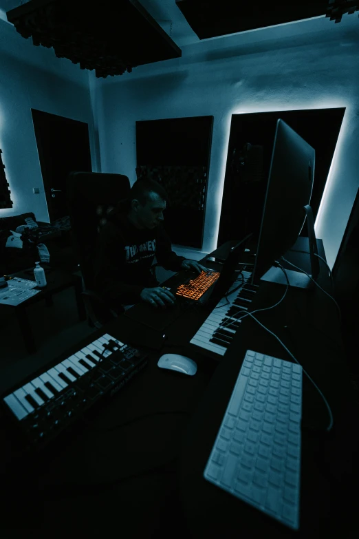 an illuminated image of a computer and keyboard