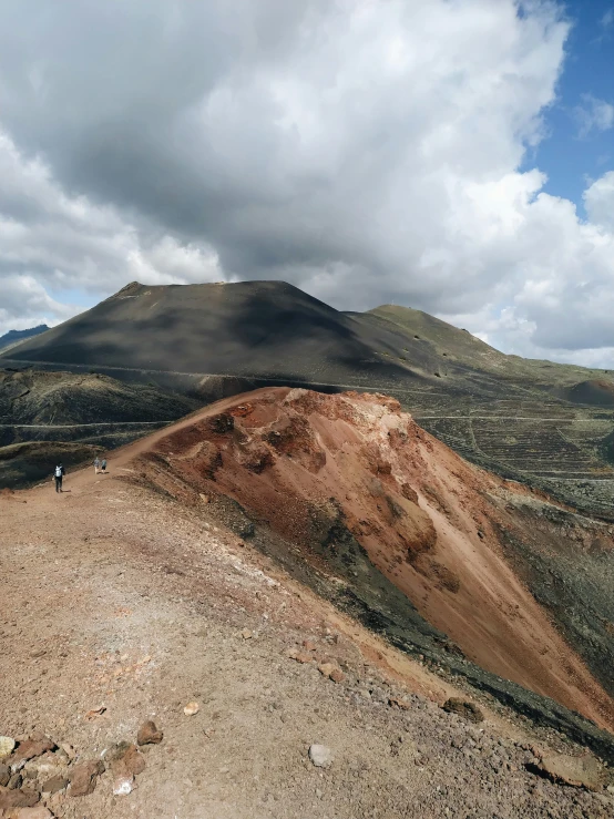 a person walking on a path near mountains