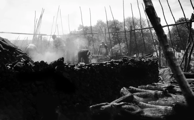 black and white image of a wood bridge with steam coming out of the top