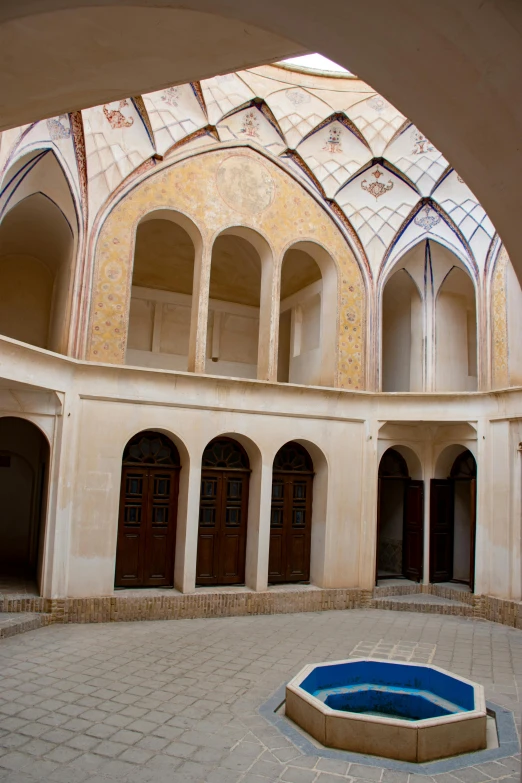 an oval pool with arches in a building