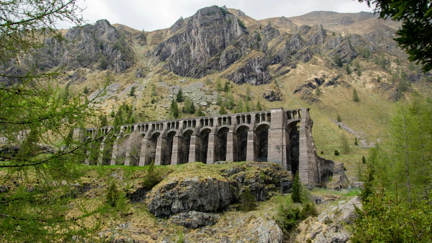 an old bridge that has been constructed into a small rock cliff