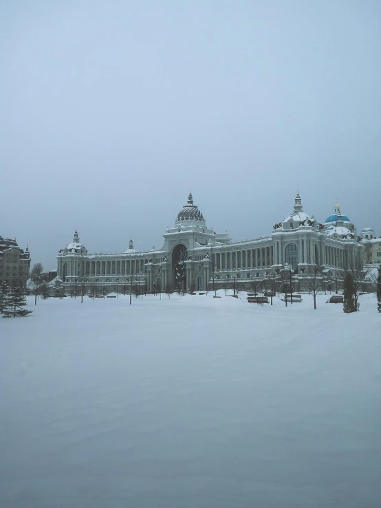 there are snow covered buildings and the sky