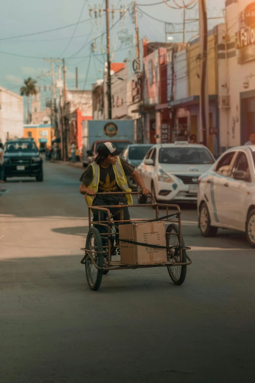 the man in the yellow vest is riding a bike