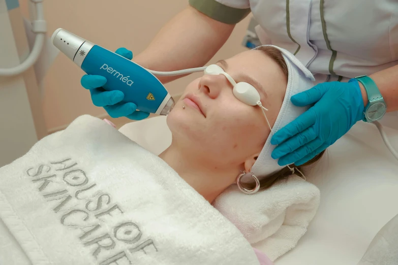 woman getting facial mask laser installed on her face