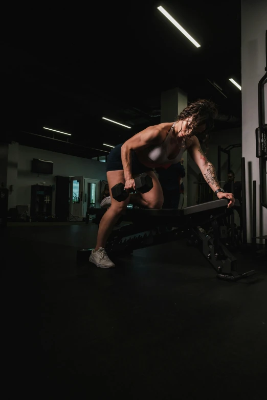 a woman is squatting down with a bar in her hand