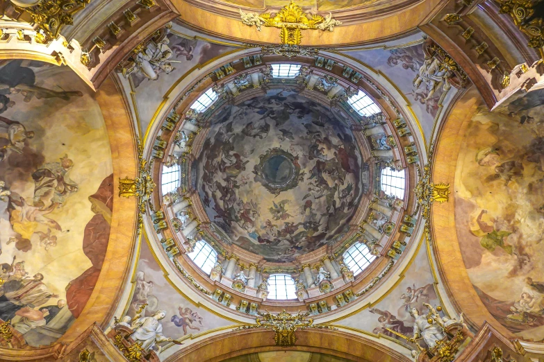 a domed ceiling inside an old building with paintings on it