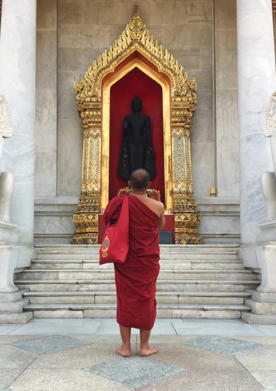 man standing outside in front of a golden throne