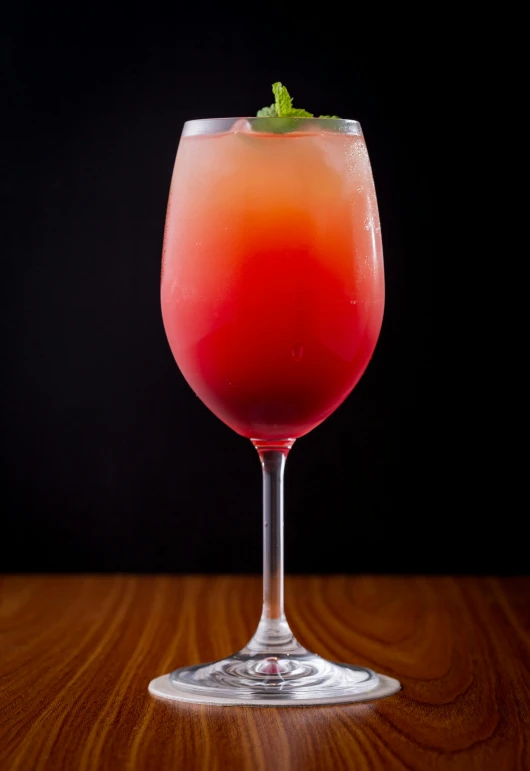 a tall glass sitting on top of a wooden table