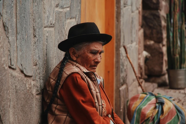 an old man with a black hat wearing a jacket and tie