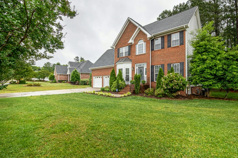 a red brick house in an open field