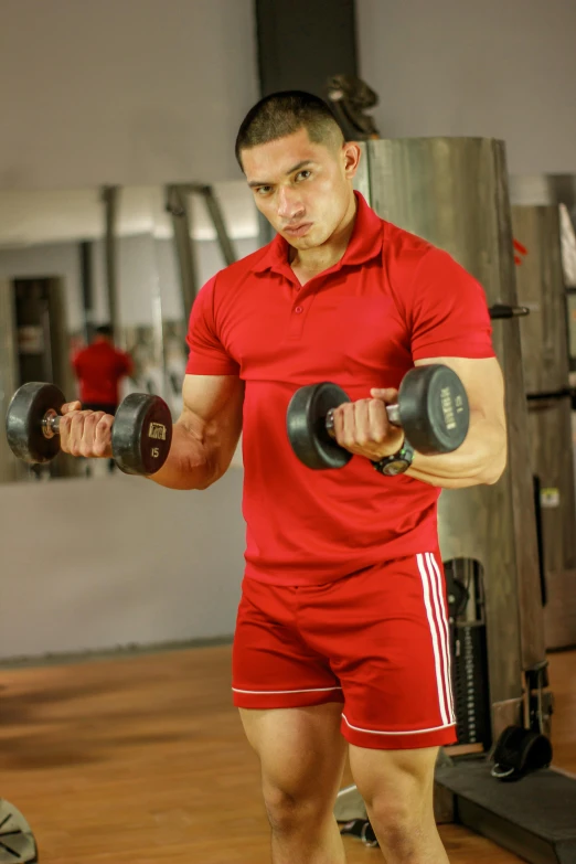 the man is lifting two different weight weights