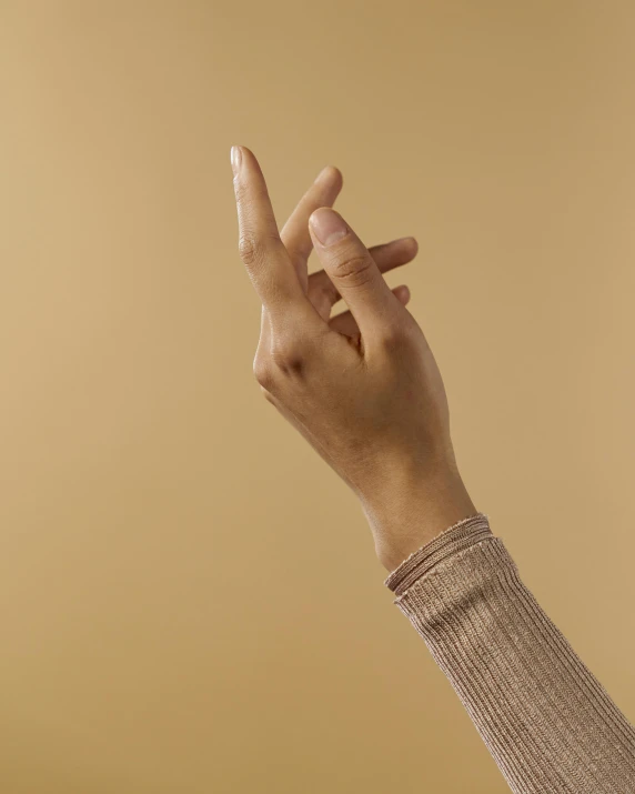 a person's hand with one end raised up, to the side