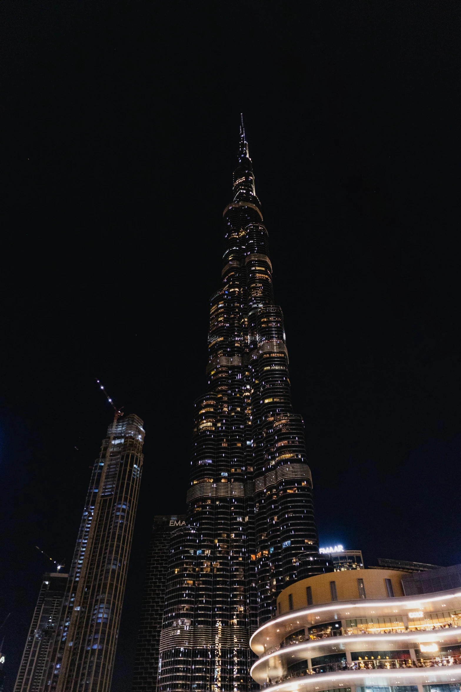 a tall building sits surrounded by smaller buildings