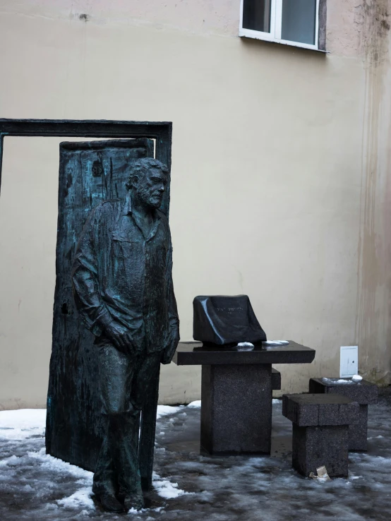 a sculpture is displayed with a laptop on the table