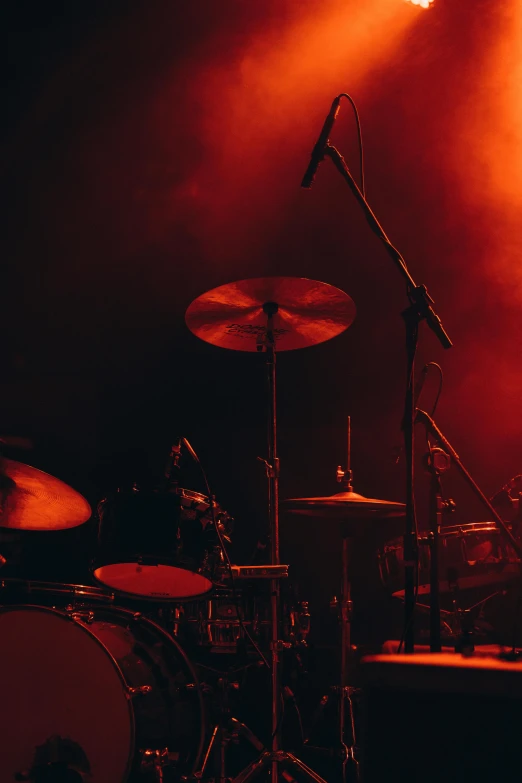 a drum set on stage in front of light spots