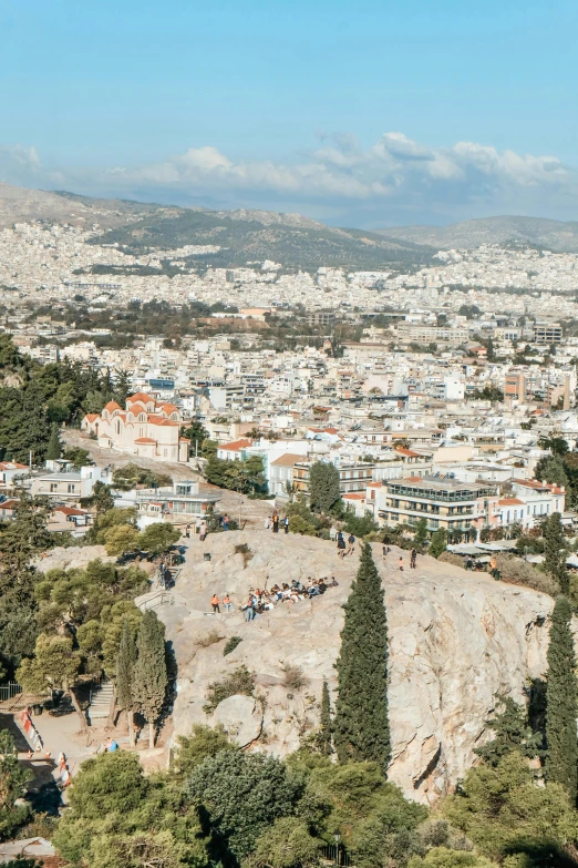 a city with people and mountains in the background