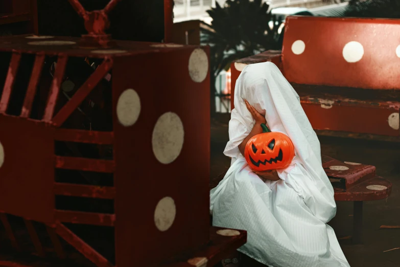 a person sitting on a bench covered with a ghost