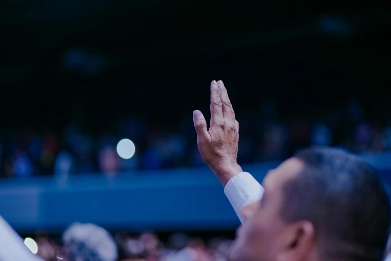 the hands of two men who are clapping