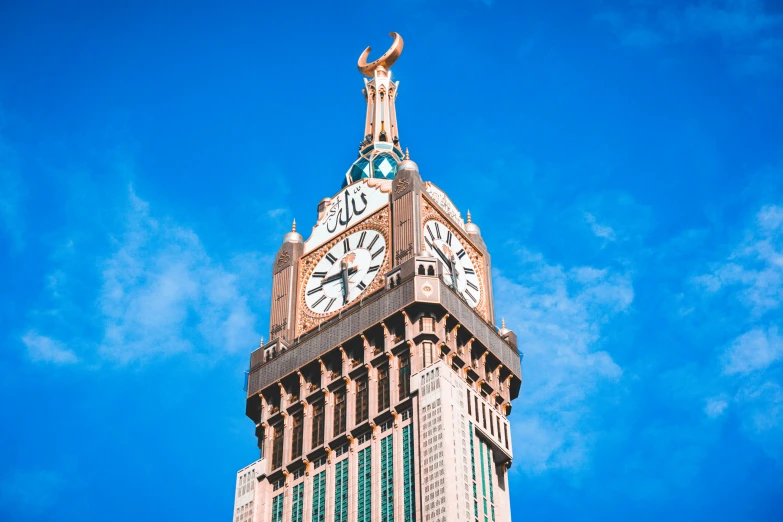 an old clock tower on a blue sky day