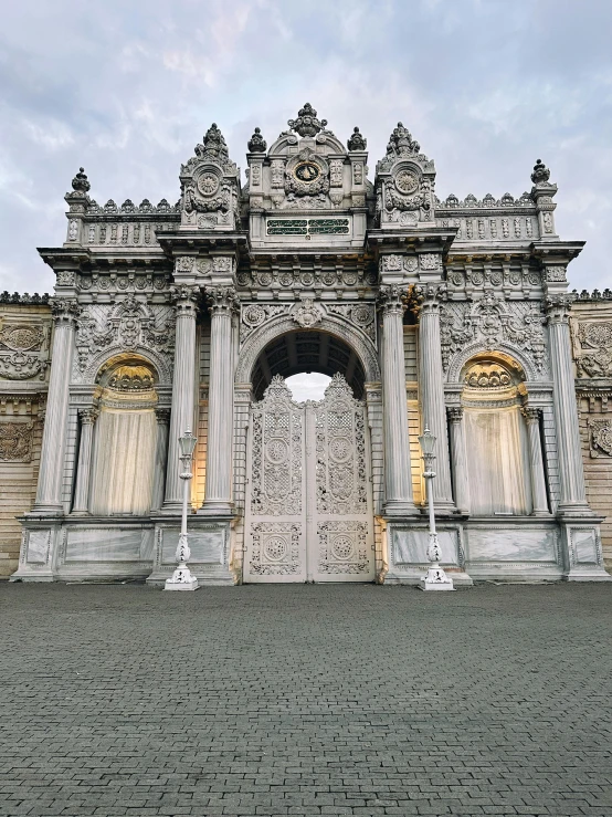 the entry of an old building with tall, elegant gates