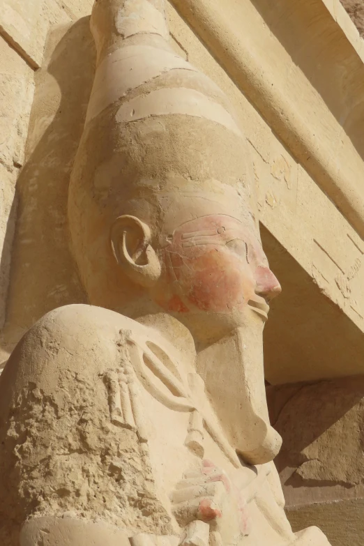 a stone sphinx on the side of a building